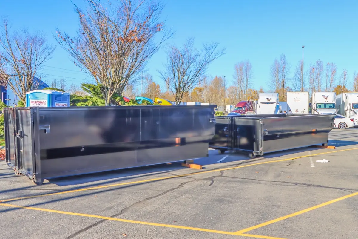 Professional dumpster rental service with roll-off container on residential driveway in Land O' Lakes